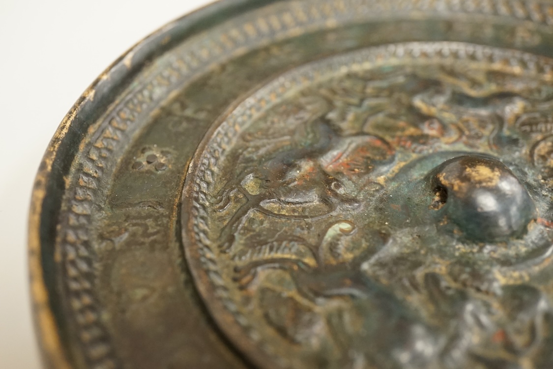 Two Chinese metal hand-mirrors, largest 13cm